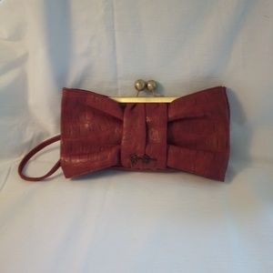 Red leather bow clutch.